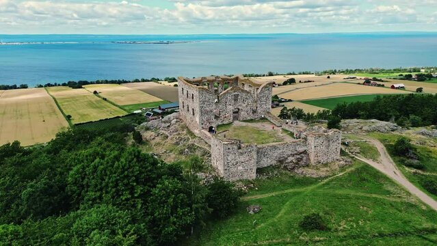 Aerial of the Brahehus Castle, a stone castle built in the 1600s, Småland, Sweden. In the background is Vättern Lake. Drone orbitshot