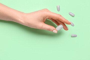 Woman with press-on nails on green background