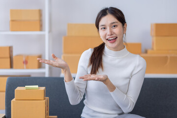 Portrait of Starting small businesses owners female entrepreneurs working on receipt box and check online orders to prepare to pack the boxes, sell to customers, sme business ideas online.
