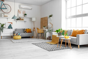 Interior of bright living room with cozy sofas, coffee table and comfortable workplace