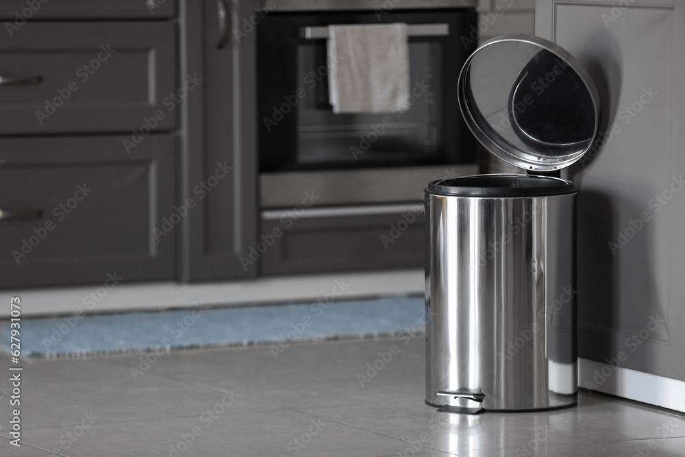 Sticker Opened metallic trash bin on floor in modern kitchen