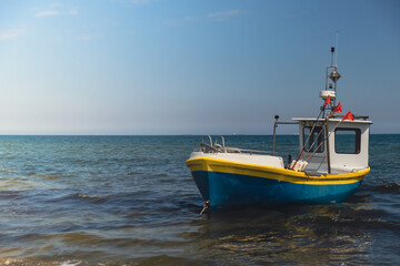 Fototapeta na wymiar Fishing boat on the beach in Sopot, Poland. Magnificent long exposure calm Baltic Sea. Wallpaper defocused waves. Fishermans sea bay Vacation and holidays. travel attraction tourist destination 