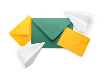 Envelopes with card and paper planes on white background