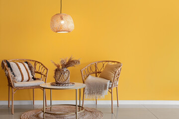 Interior of stylish room with glowing ceiling lamp, table and chairs
