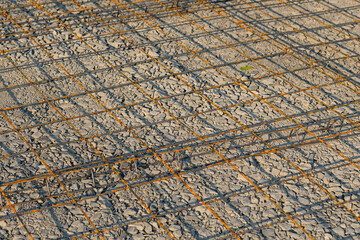 Welded wire mesh, WWM, installed within a sidewalk concrete form prior to the installation of concrete. 