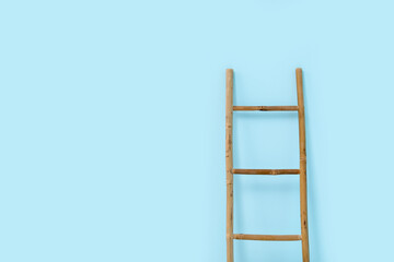 Wooden ladder near blue wall in room
