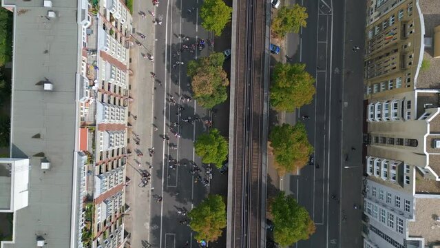 suburban railroad, Magic aerial top view flight 
CSD Pride Love Parade 2023 in city Berlin Germany Summer day. vertical bird's eye view drone
4K Cinematic footage.