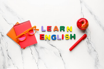 Text LEARN ENGLISH and stationery on grunge white background