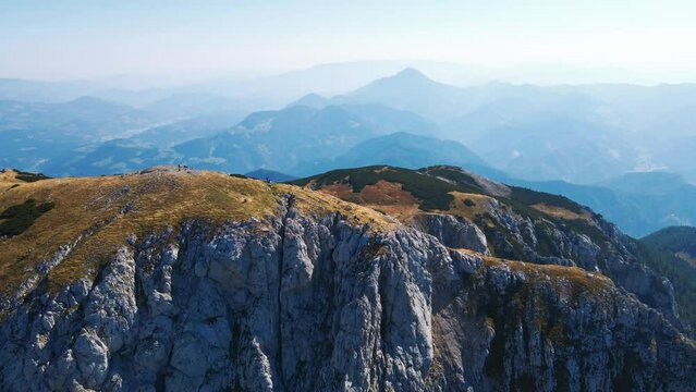 Stunning 4K drone footage of Saddle bellow Kordezeva Glava - Peca mountain in Karavanke mountain range. Beautiful Slovenian scenery of peaks of Kamnik-Savinja Alps in the background. Summer time.