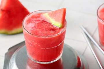 Glass of tasty watermelon fresh on white tile background