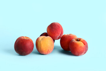 Sweet peaches on blue background