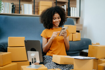 Small business entrepreneur SME freelance African woman working at home office, BOX,tablet and laptop online, marketing, packaging, delivery,  e-commerce concept