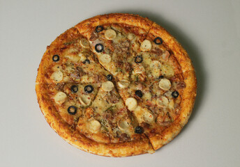 Delicious pizza with olives and sausages on wooden table, top view