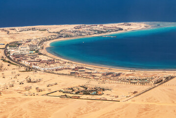 Aerial View of the Red Sea Coast in Hurghada, Egypt with many hotels bay out of airplane landing - 627948817