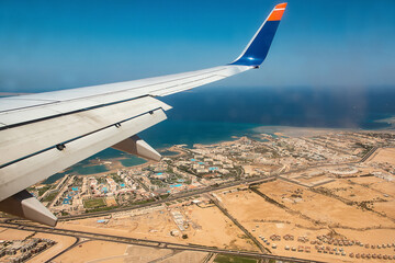 Aerial View of the Red Sea Coast in Hurghada, Egypt with many hotels bay out of airplane landing