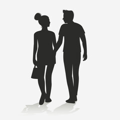 Silhouette of a couple walking while chatting