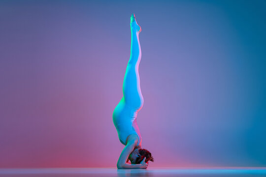 Female with big jelly cross legs sit on the mat relax after yoga