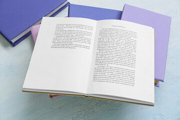 Open book on light blue table