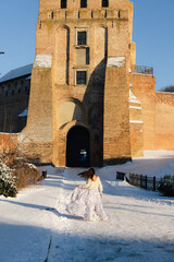 Girl in a white dress on a photo of the castle