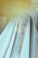 Close-up of a girl under a veil against the background of lanterns