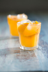 Orange juice on a rustic wooden table.
