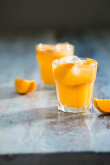Orange juice on a rustic wooden table.