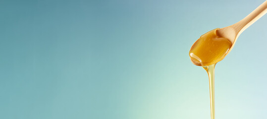 Liquid honey on spatula, flowing, dripping