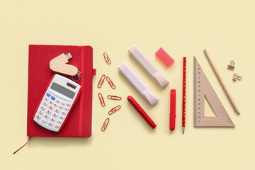 Different school stationery and notebook on beige background
