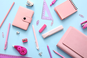 Different school stationery and notebooks on blue background