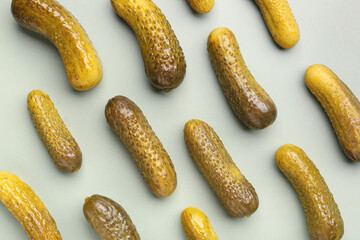 Pickled cucumbers on green background