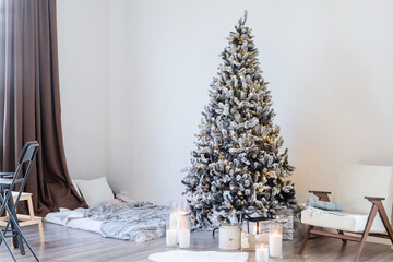 Christmas tree with presents and lights in light and airy living room