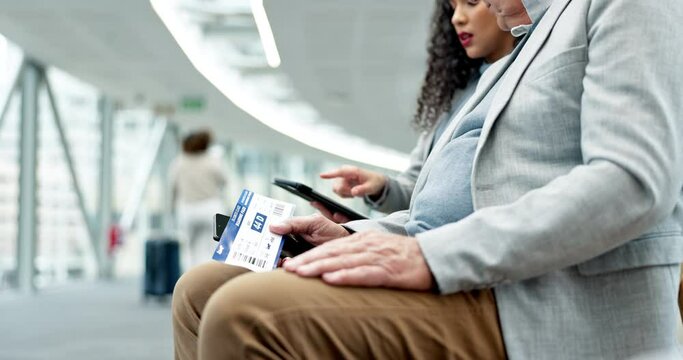 Talking, business people and ticket at the airport for travel, planning on tech and waiting for a flight. Corporate, speaking and employees sitting together with a boarding pass and tablet for a trip