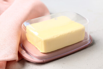 Box with fresh butter on white background