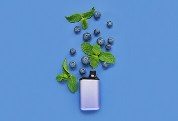 Electronic cigarette with blueberry and mint on blue background