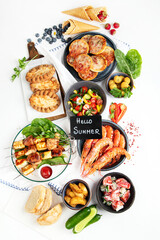 Family dinner or lunch. Many dishes on the table. Summer.