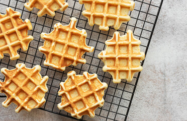 Freshly baked waffles on a baking rack.