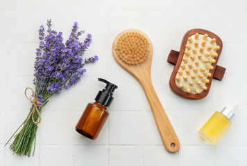 Fototapeta na wymiar Lavender spa. Lavender salt, natural essential oil, massage brushes and fresh lavender