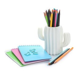 Fototapeta premium Cup in shape of cactus with school stationery and notebooks on white background