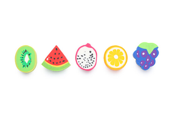 Set of erasers in shape of fruits on white background