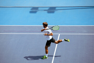 Tennis player training on a professional tennis court.