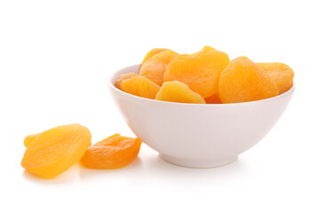 Bowl with tasty dried apricots on white background