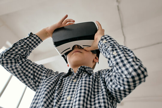 Horizontal low angle shot of boy wearing vr glasses