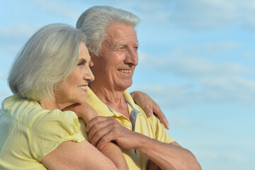 Beautiful Caucasian aged couple outdoors on a sky background