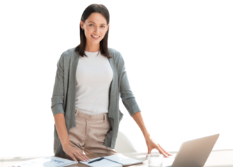 Confident young businesswoman with a friendly smile standing behind her desk on a transparent background looking at the camera.
