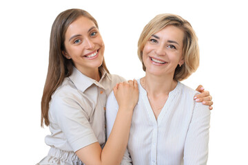 Beautiful middle aged mom and her adult daughter are hugging, looking at camera and smiling on a...