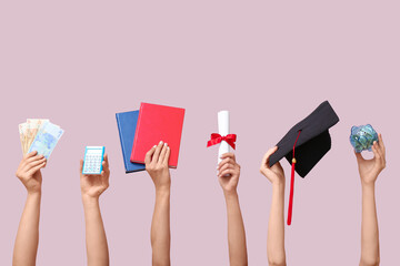 Female hands holding piggy bank, graduation cap, diploma and money on pink background. Student loan...