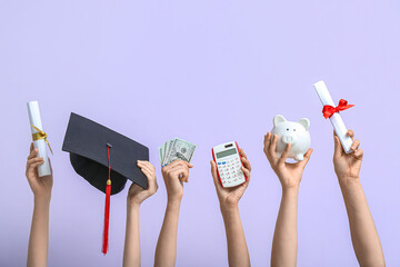Female hands holding piggy bank, graduation cap, diplomas and money on lilac background. Student...