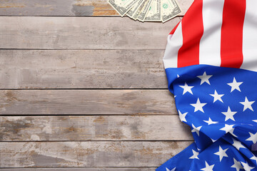 Flag of USA and dollar banknotes on wooden background