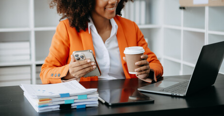 African business woman using laptop computer at modern office with blurred background