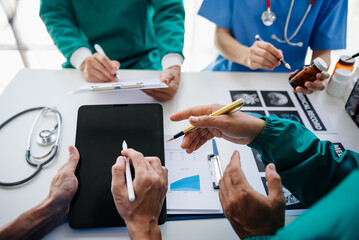 Medical technology network team meeting concept. Doctor hand working with smart phone modern digital tablet and laptop computer with graphics chart interface, with virtual icon diagram